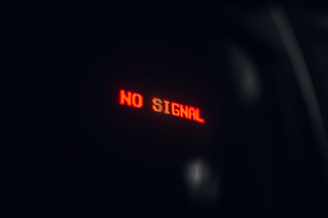 A red LED display indicating No Signal in a dark setting, conveying a tech warning.